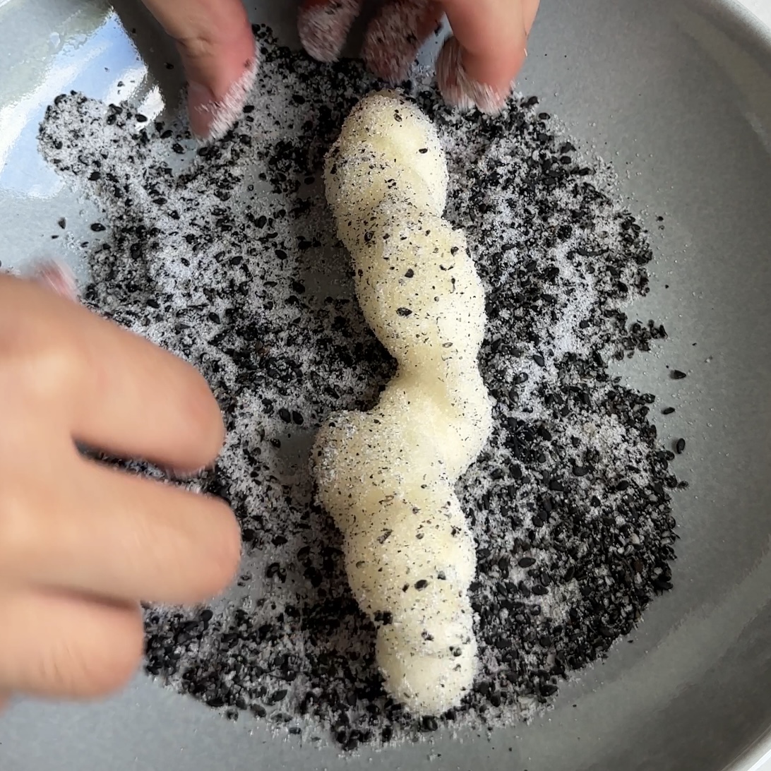 Tossing Taiwanese churro is black sesame mixture