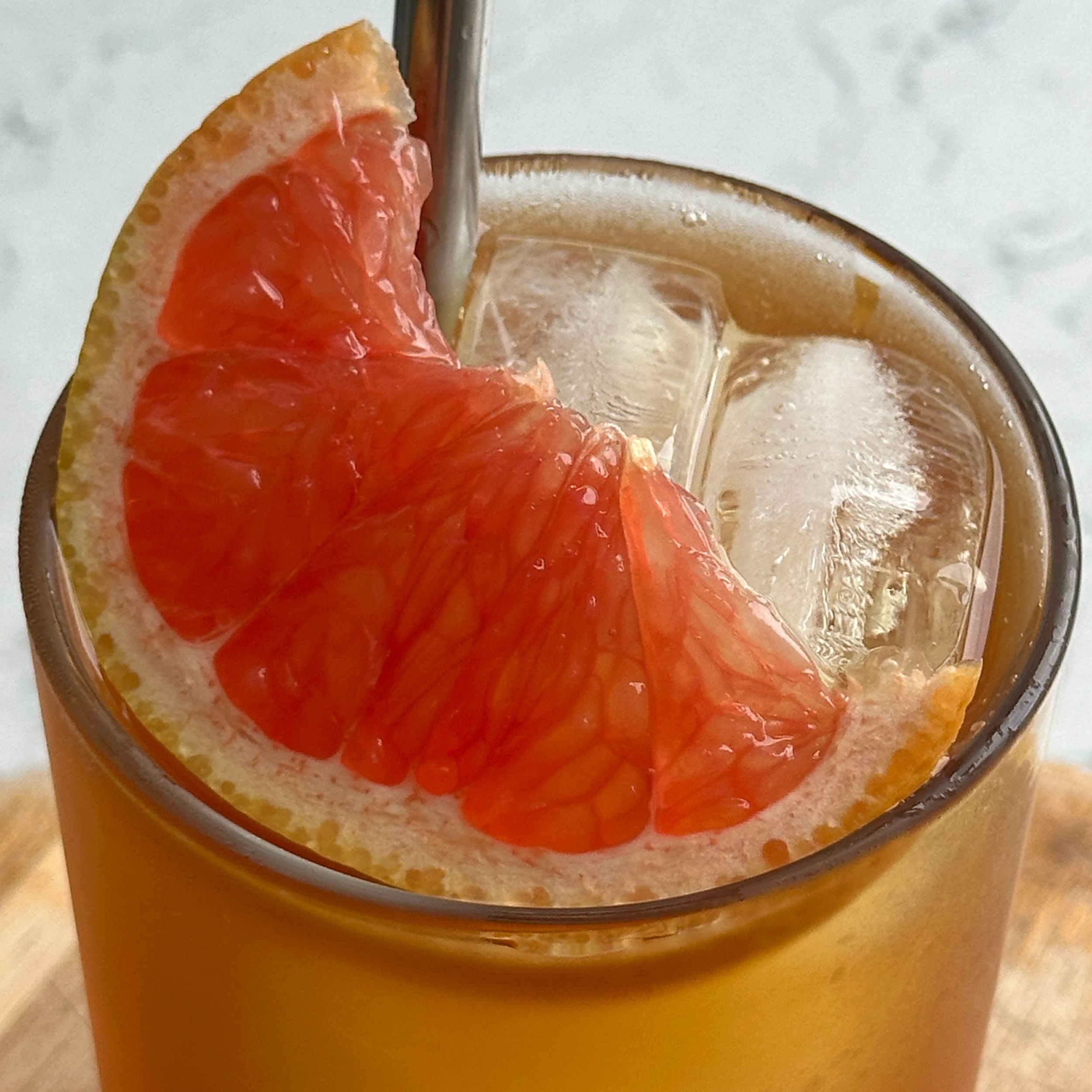 a wedge of grapefruit on a iced tea